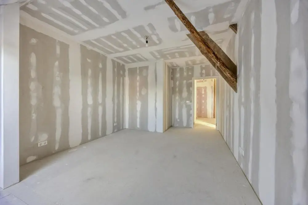 First floor: a bedroom with the braces of the timber frame on view