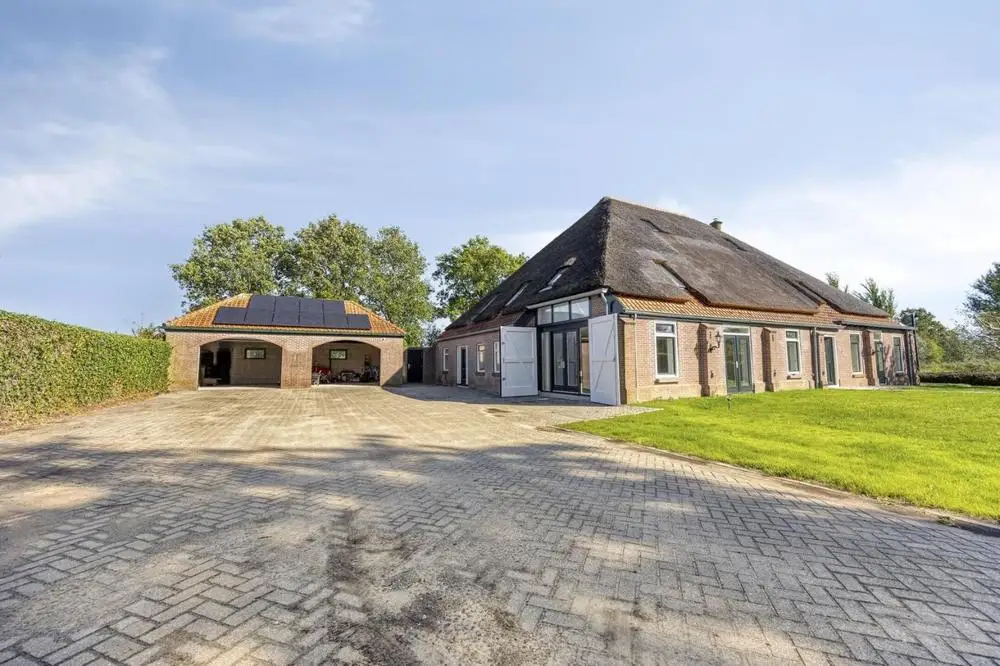 The yard with the garage block and the barn doors